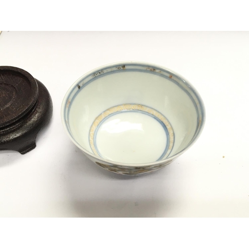 872 - An Imari bamboo and pine tea bowl raised from the wreck of the Geldermalsen with COA.