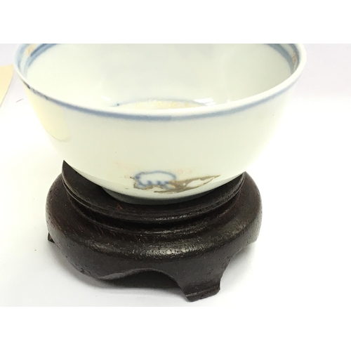 872 - An Imari bamboo and pine tea bowl raised from the wreck of the Geldermalsen with COA.