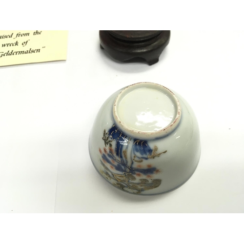 872 - An Imari bamboo and pine tea bowl raised from the wreck of the Geldermalsen with COA.