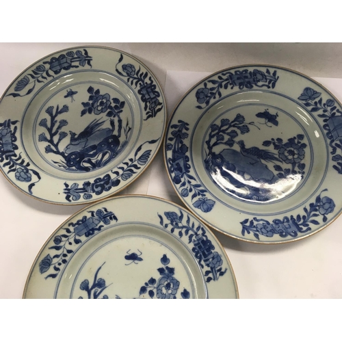 876 - Three Early 19 th Chinese blue and white plates decorated with birds flowers and foliage.