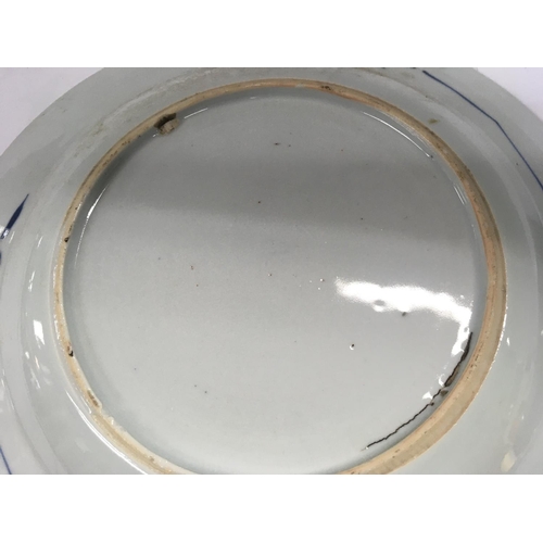 876 - Three Early 19 th Chinese blue and white plates decorated with birds flowers and foliage.