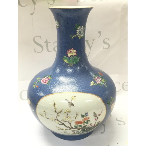 877 - A Chinese Qianlong marked vase with hand painted panel design of birds and flowers. No obvious damag... 