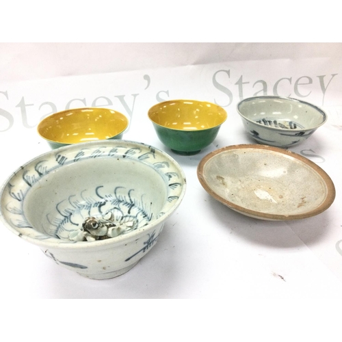 893 - A collection of Chinese bowls including yellow and green glaze, blue and white frog bowl . This lot ... 