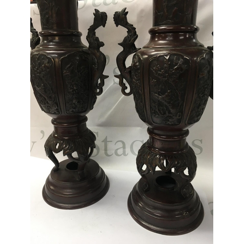 896 - A pair of Japanese bronze vases with raised birds flowers and foliage . 40 cm .