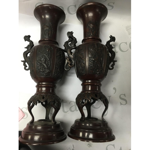 896 - A pair of Japanese bronze vases with raised birds flowers and foliage . 40 cm .