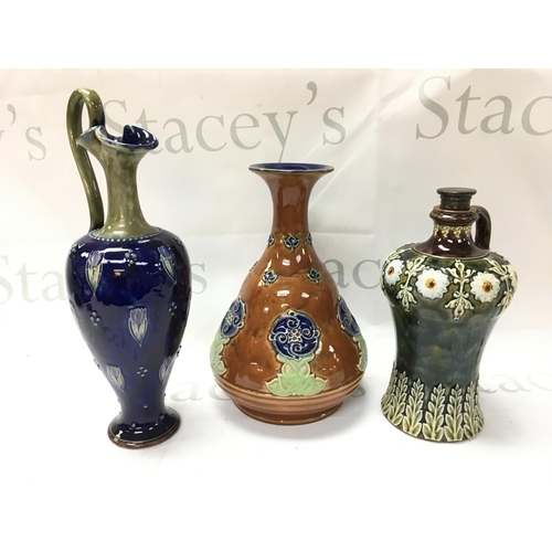 1049 - Royal Doulton Lambeth stoneware vases including a claret jug, Whiskey flagon. No obvious damage or r... 