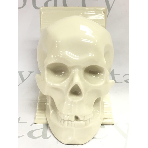 1055 - A rare Hungarian Herend ceramic skull bookend, no obvious damage or restoration . This lot cannot be... 
