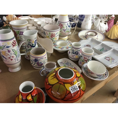 1062 - A collection of Poole pottery including lamp vases jugs vases and dishes .