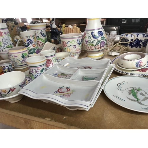 1062 - A collection of Poole pottery including lamp vases jugs vases and dishes .