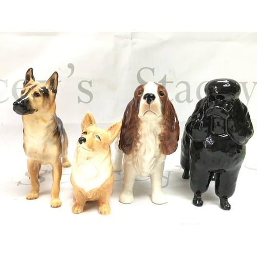 1071 - Four porcelain dog figures including Beswick, Sylvac and Royal Doulton. This lot cannot be posted