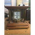 A mahogany case flip ticket clock