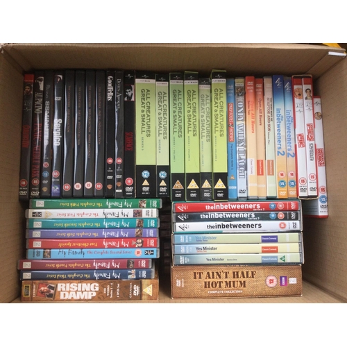 Three boxes of DVDs comprising many TV series and films.