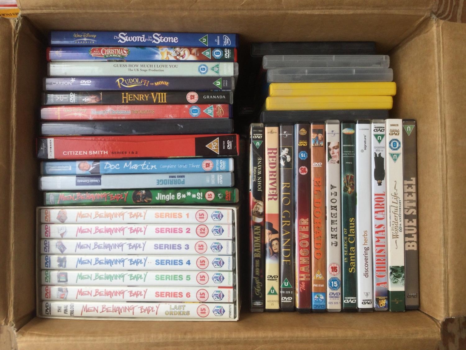 Three boxes of DVDs comprising many TV series and films.