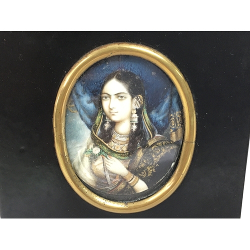 804 - A 19th century ebonised, framed portrait miniature depicting an Indian lady in traditional dress. 10... 