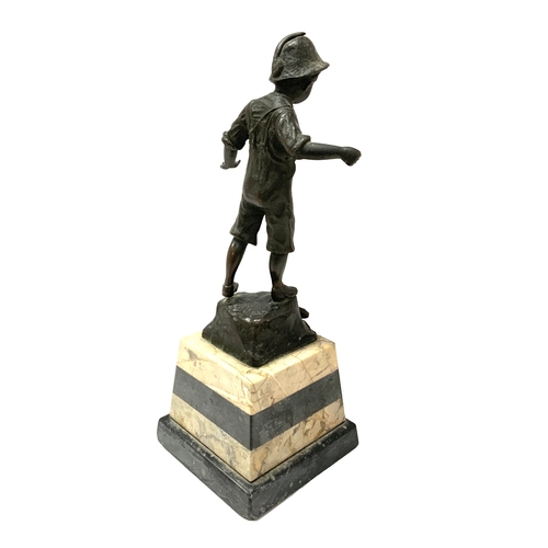 811 - A small bronze figure of a fisher boy mounted on a marble base. 27cm.