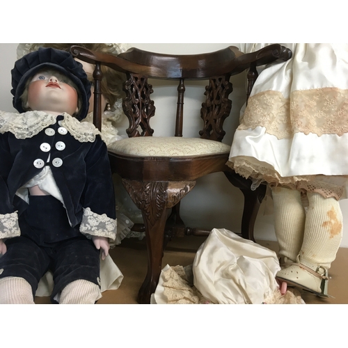 830 - Three Victorian style dolls together with a reproduction dolls corner chair (No reserve) .