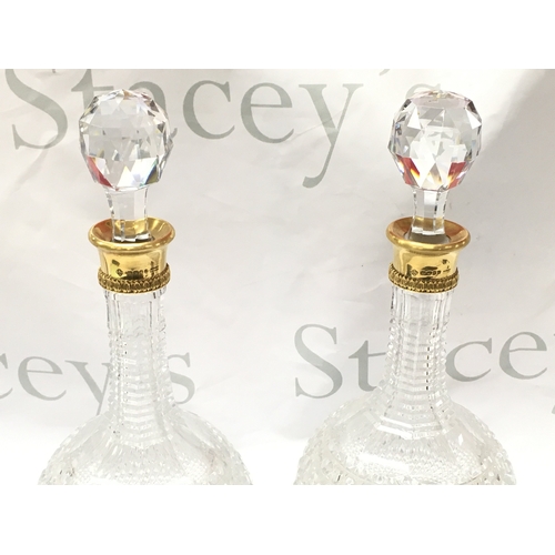 869 - A pair of fine quality 18ct gold rim and cut glass Asprey decanters ,33cm tall. This lot cannot be p... 