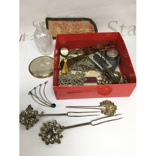 873 - A collection of items comprising vintage Oriental style hat pins, belt buckles, a Stratton compact e... 