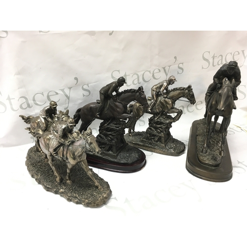 879 - Four horse and jockey statues . 19 to 29cm tall Postage category C