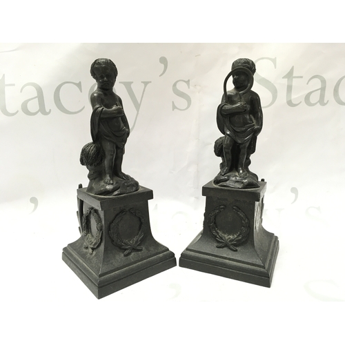 884 - A pair of 19th century bronze cherub figures with detachable bases , the base decorated with garland... 