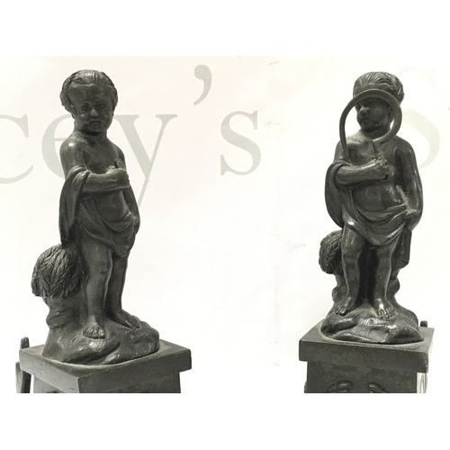 884 - A pair of 19th century bronze cherub figures with detachable bases , the base decorated with garland... 