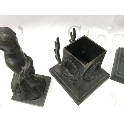 884 - A pair of 19th century bronze cherub figures with detachable bases , the base decorated with garland... 