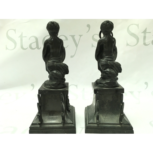 884 - A pair of 19th century bronze cherub figures with detachable bases , the base decorated with garland... 