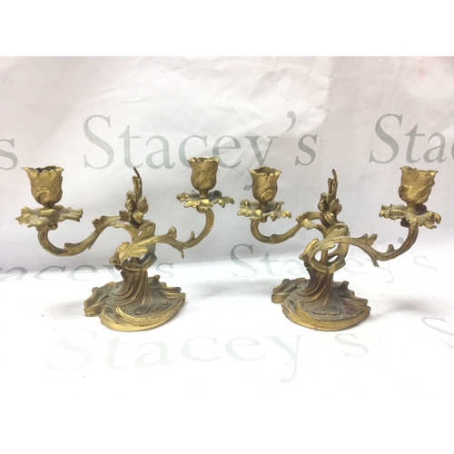 893 - A pair of French ormoulo candelabras, approximately 15cm tall. 21cm wide. Postage category c