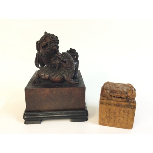 915 - Two Chinese wooden and stone Fu dog stamp seals. 6 and 15cm tall. Postage category B