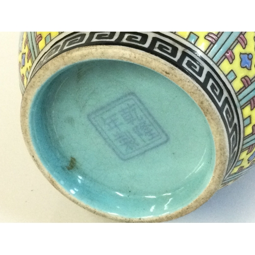 917 - A Chinese Cantonese Turquoise vase with a four character mark at base. 21cm tall.