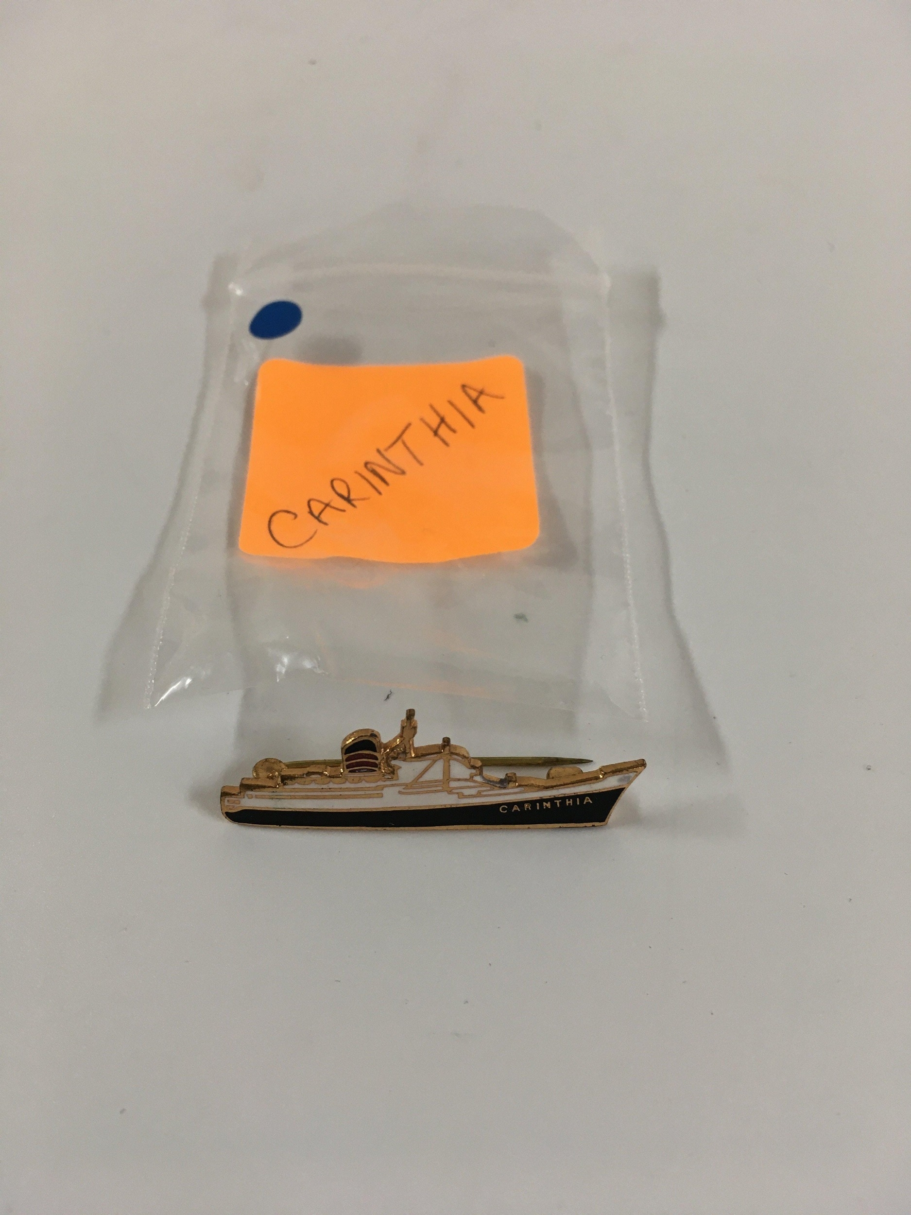A collection of lapel pin ship badges consisting of an early ship shape ...