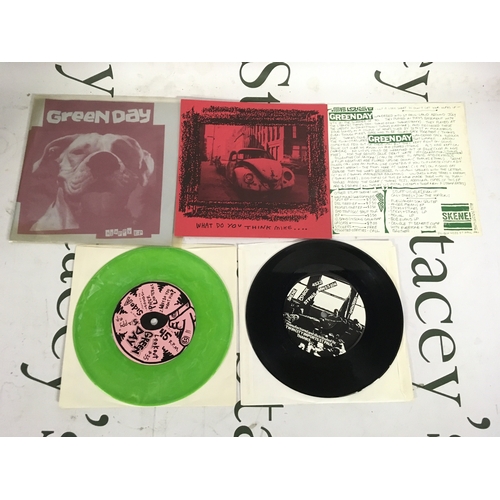 21 - Two early Green Day EPs comprising a green vinyl pressing of the Slappy EP and a limited edition rei... 