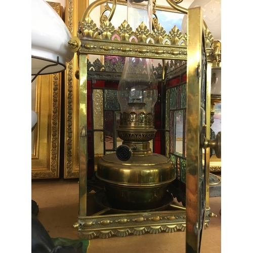 823 - A brass hanging stained glass hall lantern. . Lantern dimensions 22cm wide, 60cm tall 21cm long