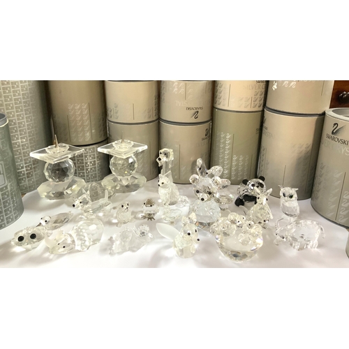 1003 - A collection of small boxed Swarovski figurines.