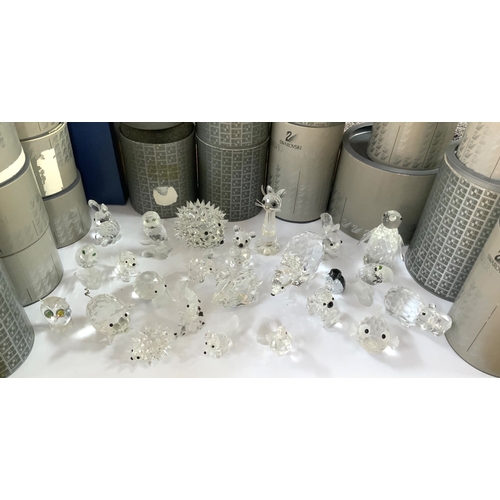 1004 - A collection of small boxed Swarovski figurines.