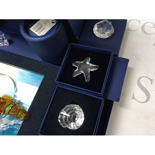 1024 - Swarovski crystal glass two boxed wonders of the sea figure groups Harmony and Eternity , also inclu... 