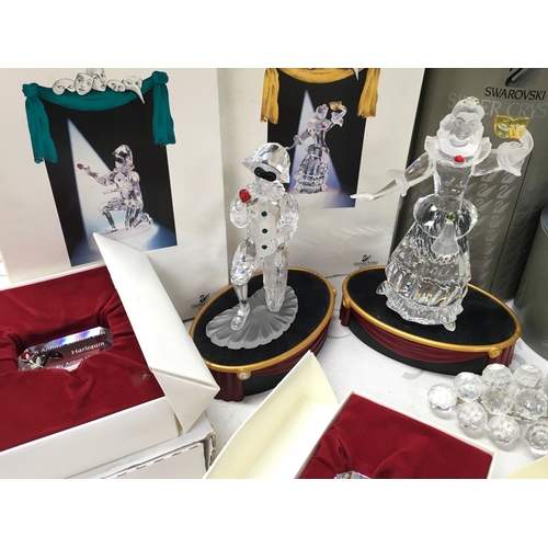 1026 - A Collection of boxed Swarovski crystal glass figures including Masquerade Columbine and Harlequin w... 