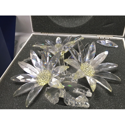 1027 - Swarovski boxed crystal glass figures including a stag, Masquerade Pierrot figure with stand and pla... 