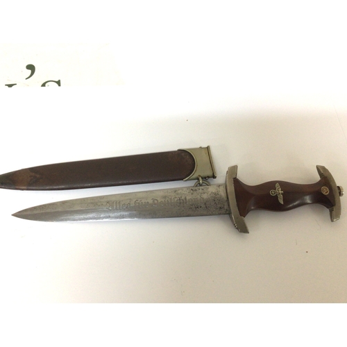 606 - A German Third Reich Genuine SA presentation dagger the walnut grip with red SA symbol inset engrave... 