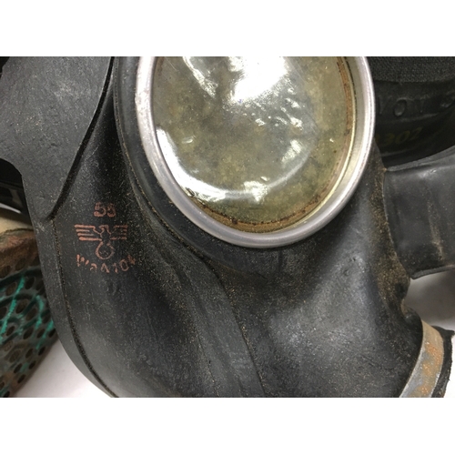 623 - A collection of gas masks including a Third Reich children's mask, British civilian duty respirator,... 