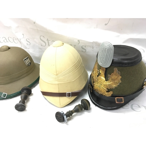 624 - Three reproduction military hats (Afrika Korps, British and German WW1 Jeager) and two stamps. No re... 