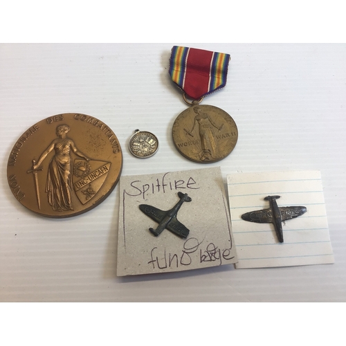 637 - An American World War II medal. A Union National medallion and Spitfire fund badges.