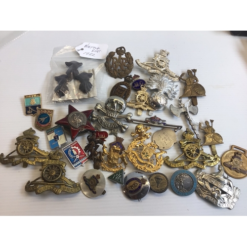 642 - A collection of military badges mainly British and including a CCCP Russian badges a red enamel star... 