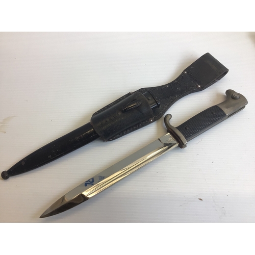 645 - A German Third Reich K98 dress bayonet makers stamp WKC with a leather frog.