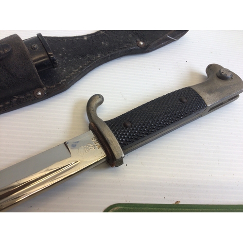 645 - A German Third Reich K98 dress bayonet makers stamp WKC with a leather frog.