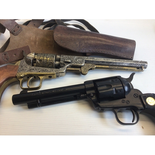 647 - Two Replica Vintage revolvers non firing ornaments. With a leather holster.