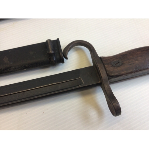 650 - A Japanese II world war Arisaka bayonet. The blade marked with three entwined circles hook quilon wo... 