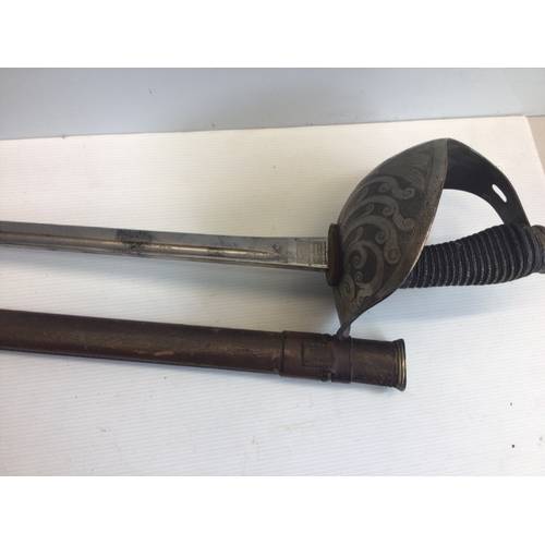658 - A good example of a British Victorian Cavalier Sword. With a solid engraved guard wired grip maker J... 