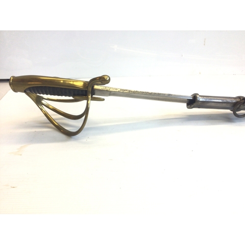 660 - A French Empire AN IV Dragoon sword with an engraved steel blade brass guard and steel scabbed.