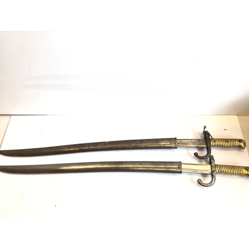688 - Two Fench 19th Century Yatagan Sword bayonets 1869 and 1870 with engraved steel blades and brass gri... 